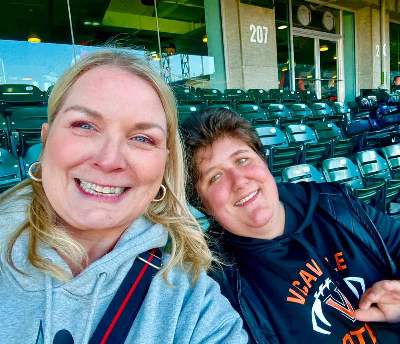 Staff and community member at a ballgame